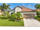 Charming home boasting a tile roof, lush landscaping, and a well-manicured lawn at 213 Malina Ct, Nokomis, FL 34275