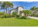 Charming single-story home with lush landscaping, palm trees, and a well-manicured lawn at 213 Malina Ct, Nokomis, FL 34275