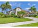 Attractive single-story home with a well-maintained lawn, beautiful palm trees, and a paved driveway at 213 Malina Ct, Nokomis, FL 34275