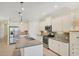 Modern kitchen featuring stainless steel appliances, granite countertops, and white cabinetry at 213 Malina Ct, Nokomis, FL 34275