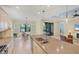 Island kitchen with stainless appliances and a bright breakfast nook overlooking the water at 213 Malina Ct, Nokomis, FL 34275