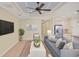 A modern living room is styled with a large TV, comfortable seating, and stylish decor at 213 Malina Ct, Nokomis, FL 34275