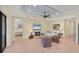 A cozy living room next to kitchen features a fireplace, comfortable seating, and tile flooring at 213 Malina Ct, Nokomis, FL 34275