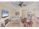 A cozy living room next to kitchen features a fireplace, comfortable seating, and tile flooring at 213 Malina Ct, Nokomis, FL 34275