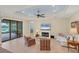 Inviting living room with tile flooring, lake view, fireplace, and casual seating in a well lit space at 213 Malina Ct, Nokomis, FL 34275