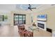 Relaxing living room with tile floors, lake view, fireplace, and casual seating in a bright space at 213 Malina Ct, Nokomis, FL 34275