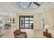 Open-concept living space with tile flooring, patio access, and comfortable seating in a well lit space at 213 Malina Ct, Nokomis, FL 34275