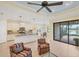 Open-concept living space with combined kitchen, patio access, tile flooring and comfortable seating at 213 Malina Ct, Nokomis, FL 34275
