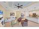 A cozy living room next to kitchen features a fireplace, comfortable seating, and tile flooring at 213 Malina Ct, Nokomis, FL 34275