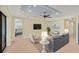 A modern living room is styled with a large TV, comfortable seating, and stylish decor at 213 Malina Ct, Nokomis, FL 34275