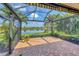 Screened patio showcasing serene lake views and lush landscaping, providing a perfect spot for outdoor living and relaxation at 213 Malina Ct, Nokomis, FL 34275