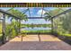 Screened-in patio offering serene views of the lake and surrounding greenery, a tranquil space for relaxation and enjoyment at 213 Malina Ct, Nokomis, FL 34275