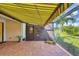 Spacious outdoor patio with retractable awning, offering picturesque views of the lake and lush greenery for serene enjoyment at 213 Malina Ct, Nokomis, FL 34275