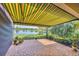 Beautiful brick patio with awning overlooking serene lake views and landscaped yard at 213 Malina Ct, Nokomis, FL 34275