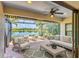 A covered outdoor patio featuring comfortable seating and scenic lake views, perfect for relaxation and entertaining at 213 Malina Ct, Nokomis, FL 34275
