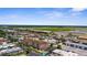 Beautiful aerial view of the community, pool, and nearby airport at 235 Base E Ave # 207, Venice, FL 34285