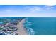 Expansive aerial perspective captures the serene coastline, sandy beaches, and charming beachfront community at 235 Base E Ave # 207, Venice, FL 34285
