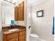 Bathroom featuring a vanity with granite countertops, wood cabinets, and a toilet at 235 Base E Ave # 207, Venice, FL 34285