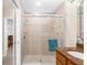 Bathroom features a glass enclosed shower with tile surround and a vanity with granite countertop at 235 Base E Ave # 207, Venice, FL 34285