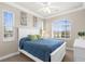 Bright bedroom featuring a white bed frame, a ceiling fan, and multiple windows with views at 235 Base E Ave # 207, Venice, FL 34285