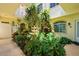 Lush courtyard showcasing a fountain, tropical plants, and architectural charm at 235 Base E Ave # 207, Venice, FL 34285