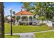 Charming community gazebo on a lush green lawn offers a peaceful outdoor gathering space with benches at 235 Base E Ave # 207, Venice, FL 34285