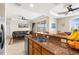 A modern open kitchen with bar seating seamlessly connects to a spacious living area, perfect for entertaining at 235 Base E Ave # 207, Venice, FL 34285