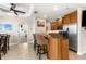A stylish kitchen bar with granite countertops, stainless appliances, and barstool seating overlooks the dining room at 235 Base E Ave # 207, Venice, FL 34285
