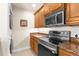 A stylish kitchen features modern appliances, granite counters, and ample cabinet space, with a stacked washer and dryer at 235 Base E Ave # 207, Venice, FL 34285