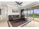 Spacious living room with tile flooring, fan, and sliding glass doors leading to the outdoor porch at 235 Base E Ave # 207, Venice, FL 34285