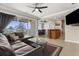 An open-concept living area boasts a comfortable sofa, open kitchen, and access to a screened-in patio at 235 Base E Ave # 207, Venice, FL 34285