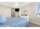 Primary bedroom with a large mirror above the dresser, fan, and a large window at 235 Base E Ave # 207, Venice, FL 34285