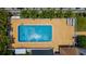 A top-down view of a refreshing outdoor swimming pool with a sun-soaked deck, perfect for relaxation at 235 Base E Ave # 207, Venice, FL 34285