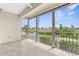 Outdoor porch with tile flooring, ceiling fan, and open views of the neighborhood at 235 Base E Ave # 207, Venice, FL 34285