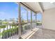 Open porch with tile flooring and views of the street and neighborhood greenery at 235 Base E Ave # 207, Venice, FL 34285
