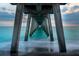 Dramatic perspective under a pier, showcasing symmetrical columns meeting the ocean and sky at the horizon at 235 Base E Ave # 207, Venice, FL 34285