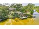 Aerial view of the home with a private dock on the water, surrounded by lush greenery at 249 Hallcrest Ter, Port Charlotte, FL 33954