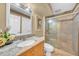 Bathroom featuring a granite vanity, stylish framed mirror, and a glass enclosed shower at 249 Hallcrest Ter, Port Charlotte, FL 33954