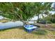 Picturesque view of a private backyard dock with a boat and seating area overlooking the tranquil waterfront at 249 Hallcrest Ter, Port Charlotte, FL 33954