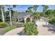 Beautiful home featuring a well-maintained lawn and a circular driveway at 249 Hallcrest Ter, Port Charlotte, FL 33954