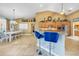 Open kitchen area featuring a breakfast bar, wood cabinets, stainless appliances, and tiled floors at 249 Hallcrest Ter, Port Charlotte, FL 33954