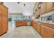 Spacious kitchen featuring wood cabinets, granite countertops, and stainless steel appliances at 249 Hallcrest Ter, Port Charlotte, FL 33954