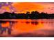 Stunning sunset over the lake, painting the water with warm hues, creating a peaceful waterfront scene at 249 Hallcrest Ter, Port Charlotte, FL 33954