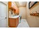 Bright laundry room with built in cabinets and sink, plus washer and dryer at 249 Hallcrest Ter, Port Charlotte, FL 33954