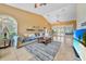 Open living room with tile flooring, comfortable seating, and sliding glass doors to the lanai at 249 Hallcrest Ter, Port Charlotte, FL 33954