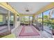 Screened patio with comfortable seating arrangements and brick flooring at 249 Hallcrest Ter, Port Charlotte, FL 33954