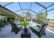 An outdoor pool area surrounded by brick pavers, tropical plants, and patio furniture at 249 Hallcrest Ter, Port Charlotte, FL 33954