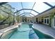 Screened-in pool area with a patio and lush landscaping creating a private outdoor oasis at 249 Hallcrest Ter, Port Charlotte, FL 33954