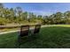 Private backyard with lawn chairs overlooking a peaceful waterfront view at 25050 Sandhill Blvd # 6A3, Punta Gorda, FL 33983