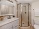 Bathroom vanity featuring marble countertop, vanity, and a glass shower with tan marble surround at 25050 Sandhill Blvd # 6A3, Punta Gorda, FL 33983